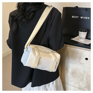 Detail of canvas messenger bag with adjustable wide strap and buckle strap closure