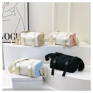 Detail view of multi-color minimalist cylinder nylon crossbody bags with buckles