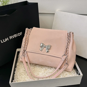 Pink bow shoulder bag with metal chain strap displayed in a premium gift box