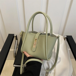 Minimalist sage green tote bag with golden lock and detachable strap for daily commuting