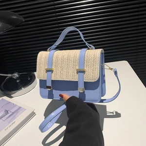Blue leather and beige woven straw crossbody bag with gold buckle and top handle detail