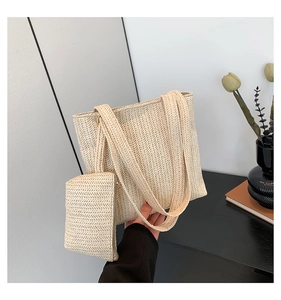 Detail of cream woven tote bag set with matching small zipper pouch and natural texture