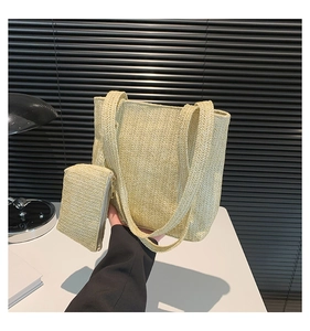 Detail of wheat straw woven tote bag with matching zippered pouch and herringbone texture