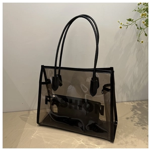 Macro detail of smoke gray PVC tote bag with Fashion print and black inner pouch
