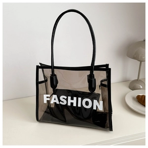 Detail of semi-transparent black PVC tote bag with Fashion text and inner pouch