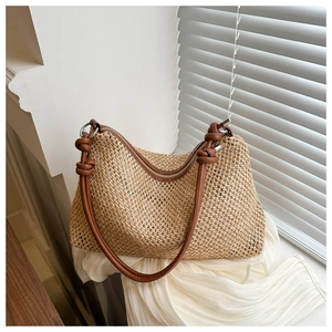 Detail of woven beige texture and brown leather knotted strap with silver ring buckle