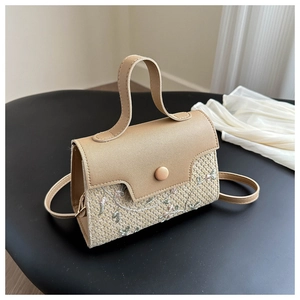 Detail showing elegant floral embroidery and woven texture on a stylish square handbag