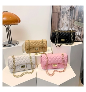 Quilted crossbody bags in black, pink, white, and beige with gold chain and turn-lock