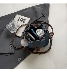 Spacious interior of blue denim bucket bag showing phone and daily essentials