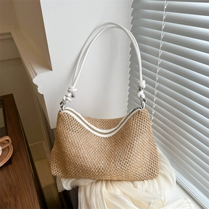Woven straw crossbody dumpling bag with white PU leather knotted shoulder strap