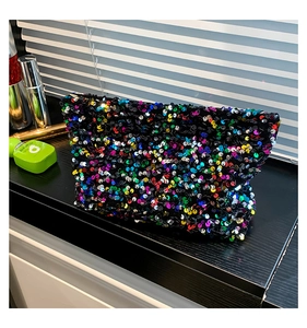 Detail of colorful sequins on black fabric cosmetic bag for party or evening