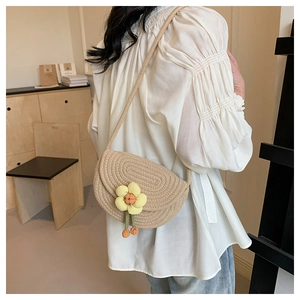 Detailed close-up of woven cotton thread shoulder bag with decorative yellow flower
