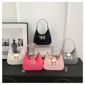 Five elegant underarm bags in various colors featuring metallic bow buckles and chains