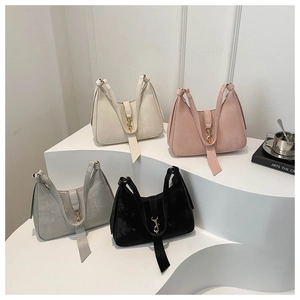 Detailed view of four semi-circle underarm bags in matte leather with gold metal buckles