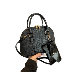 Glossy black crocodile pattern shell bag with matching small pouch and gold hardware