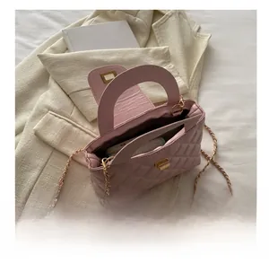 Pink quilted crossbody bag interior capacity display with chain and gold hardware