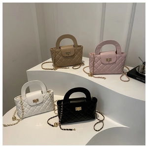 Detail showing various colors of quilted crossbody bags with gold chain and metal buckle