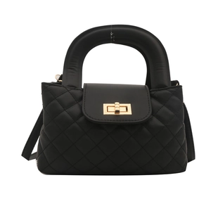 Fashionable black quilted handbag with unique padded round handle and gold clasp closure