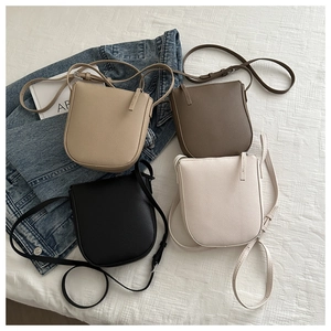 Detailed overhead view of mini saddle leather crossbody bags in four premium colors