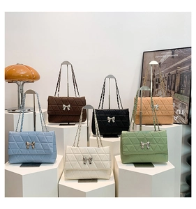 Detailed close-up of quilted chain shoulder bags with elegant metal bow buckle in six colors