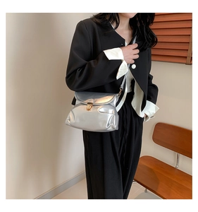 Silver metallic pleated crossbody bag featuring a gold round lock buckle and slim strap