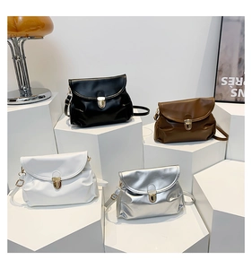 Collection of four pleated small handbags in black, brown, white and silver with gold clasps