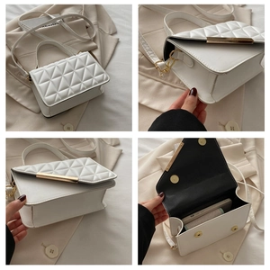 Detail view of white quilted crossbody bag with gold metal trim and interior phone space