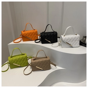 Collection of quilted crossbody bags in orange, green, black, white, and khaki colors