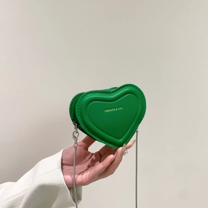Mini green heart-shaped crossbody bag with gold lettering and slim silver chain strap