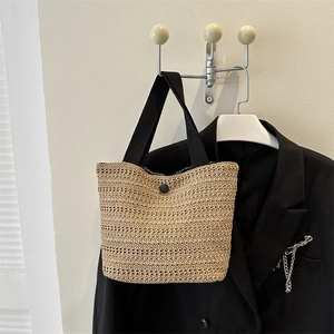 Sac fourre-tout tissé beige avec poignées noires et fermeture à bouton, style minimaliste
