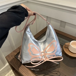 Sac à bandoulière argenté brillant avec papillons roses et détails de laçage