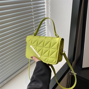 Quilted lime green crossbody handbag with geometric stitching and gold metal buckle detail