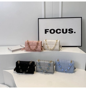 Quilted crossbody bags with chain straps in multiple colors on a minimalist display