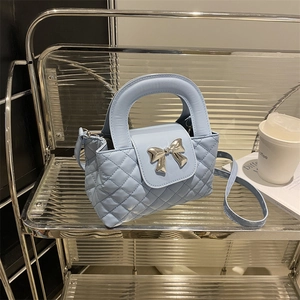 Light blue quilted leather handbag with silver metal bow and shoulder strap for women