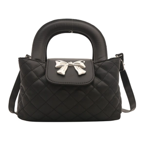 Elegant black quilted handbag with silver bow detail and stylish top handle design