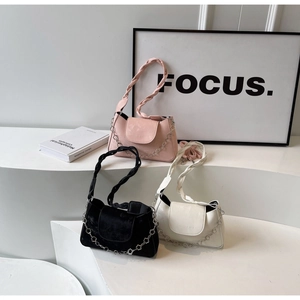 Three minimalist underarm bags in pink, black, and white featuring decorative flower chains