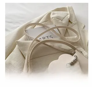 Macro shot of cream heart-shaped pocket with decorative silver bead chain detail