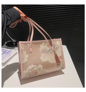 Close-up of pink floral embroidery and silk tassel on this Chinese style tote bag