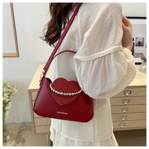 Fashionable dark red crossbody bag featuring a 3D heart with silver bead detailing