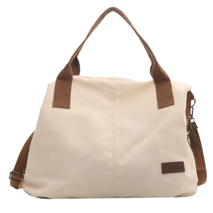 Minimalist canvas tote bag in cream and brown with crossbody strap and fashion patch