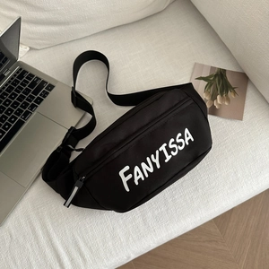 Versatile black casual fanny pack with white letter print on a white sofa scene