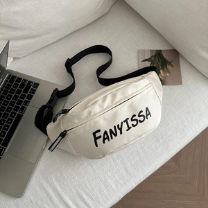 White casual sports fanny pack with black letter print on a white fabric sofa