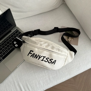 White casual nylon waist bag with letter print and plush doll charm on white sofa