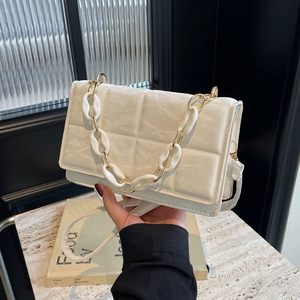 Chic white quilted chain shoulder bag with gold acrylic strap and flap closure
