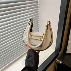 Chic off-white crescent handbag with textured faux leather and golden metal buckle
