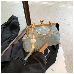Detail of light blue qipao bag with gold floral embroidery and white tassel accent