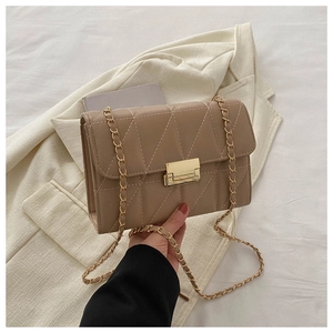Detail of khaki quilted crossbody bag with gold chain strap and metallic clasp closure