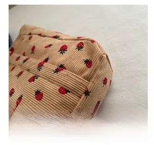 Close-up of strawberry print on corduroy tote bag showing high-quality stitching detail