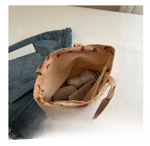 Interior view of beige corduroy tote bag with strawberry print showing large capacity
