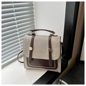 Close-up of retro square bag with canvas leather stitching and gold buckle detail
